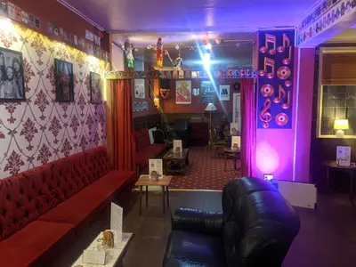 a bar with a red couch and a purple room at The Albert Hotel Near Winter Gardens in Blackpool