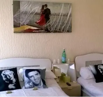 a bedroom with two beds and a picture on the wall at The Albert Hotel Near Winter Gardens in Blackpool