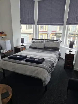 a bedroom with a bed with two towels on it at The Last Post in Blackpool
