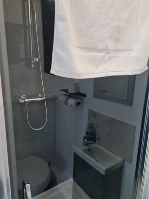 a bathroom with a toilet and a sink and a towel at The Last Post in Blackpool