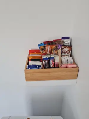 a wooden shelf with books and other items on a wall at The Last Post in Blackpool