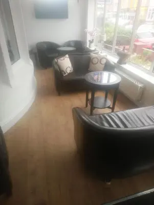 a living room with a couch and a table at The Gatsby Blackpool - Formerly The Windsor in Blackpool