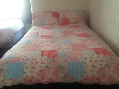 a bedroom with a bed with a quilt on it at The Midway in Blackpool
