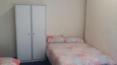 a small bedroom with a bed and a closet at The Midway in Blackpool