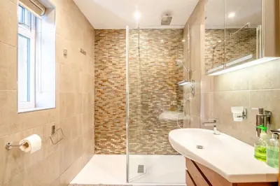 a bathroom with a shower and a sink at Palms Cottage in Blackburn