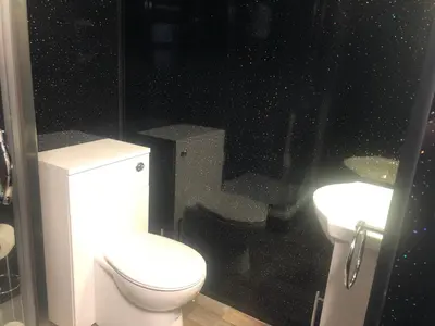 a bathroom with a toilet and a sink at Baxter Holiday Apartments in Blackpool