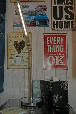 a wall with posters and a cup of coffee at The Arthington in Blackpool