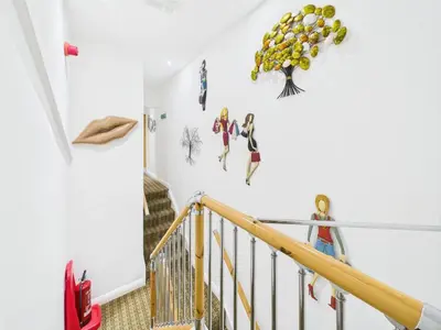 a staircase with a white wall with fruit on it at The Arthington in Blackpool