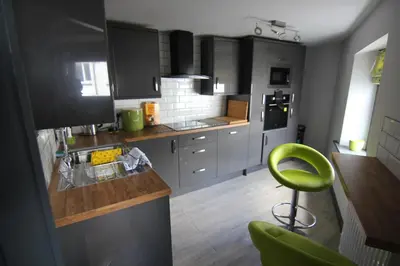 a kitchen with a green stool in a kitchen at The Warehouse in Ulverston