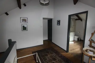 a hallway with a white wall and a mirror at The Warehouse in Ulverston
