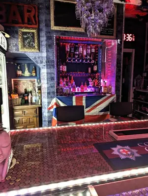 a bar with a bar counter with purple lights at The Mercury in Blackpool