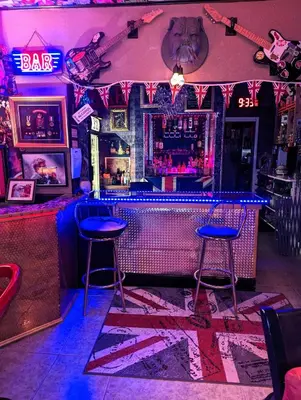 a bar with two blue stools in front of a bar at The Mercury in Blackpool