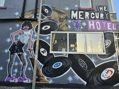a mural on the side of a building with a woman on skateboards at The Mercury in Blackpool