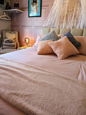 a bed with pillows on it in a bedroom at The Mercury in Blackpool