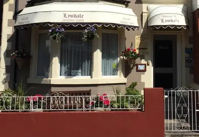 a building with a balcony with flowers on it at Lyndale Holiday Flats in Blackpool