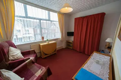 a living room with a couch and a window at Lyndale Holiday Flats in Blackpool