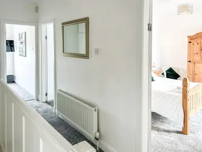 a bedroom with a bed and a mirror on the wall at Highcross in Poulton le Fylde