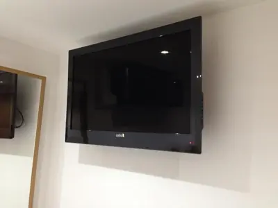a flat screen tv hanging on a wall at The Podworks Hotel in Liverpool