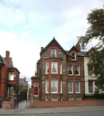an old brick house on the side of a street at Sheil Suites in Liverpool