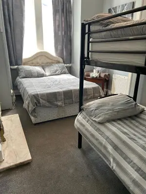 a bedroom with two bunk beds and a window at MyRoomz Golden Strand Hotel in Blackpool