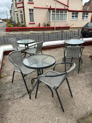 a group of tables and chairs sitting on a street at MyRoomz Golden Strand Hotel in Blackpool