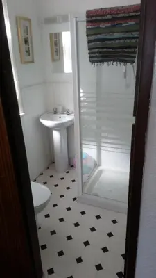 a bathroom with a shower and a toilet and a sink at MyRoomz Golden Strand Hotel in Blackpool