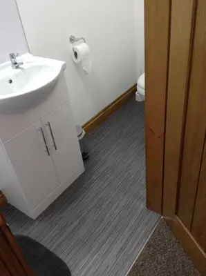 a bathroom with a sink and a toilet at The Bear On The Square in Millom