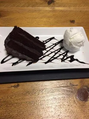 a piece of chocolate cake and ice cream on a plate at The Bear On The Square in Millom