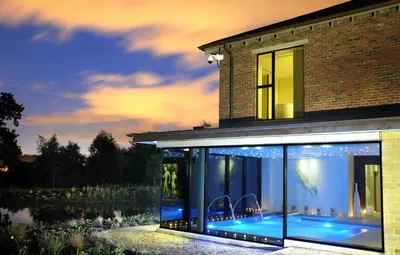 a glass house with a view of a pond at Stanley House Hotel & Spa in Blackburn