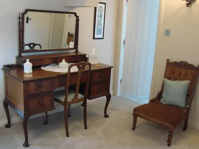 a bathroom with a dresser and a mirror and a chair at Chapel Cottage Clitheroe Road in Waddington