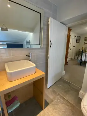 a bathroom with a sink and a mirror at Chapel Cottage Clitheroe Road in Waddington