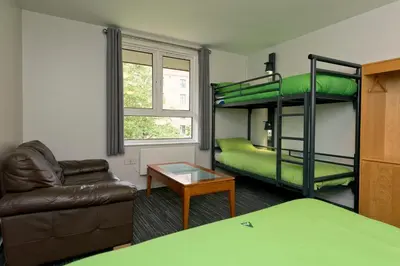 a living room with bunk beds and a couch at YHA Liverpool Albert Dock in Liverpool