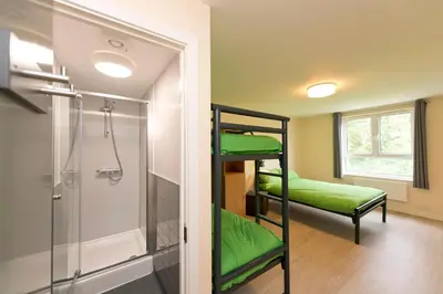 a room with two bunk beds and a shower at YHA Liverpool Albert Dock in Liverpool