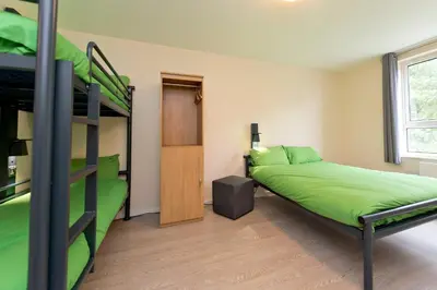 a bedroom with two bunk beds and a ladder at YHA Liverpool Albert Dock in Liverpool