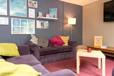 a living room with two couches and a table at YHA Liverpool Albert Dock in Liverpool