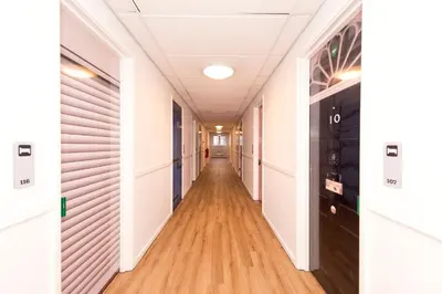a corridor in an office building with a long hallway at YHA Liverpool Albert Dock in Liverpool