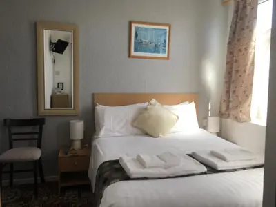 a bedroom with a bed with towels on it at The Address in Blackpool