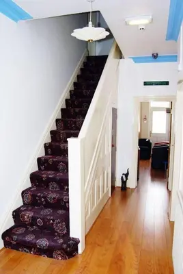 a staircase in a house with a rug on it at The Address in Blackpool