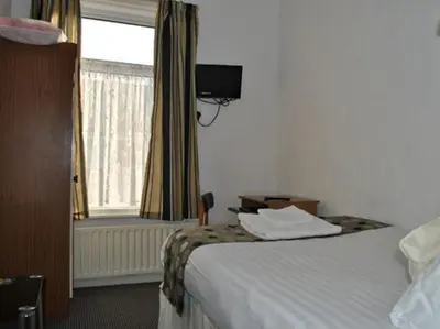 a hotel room with a bed and a window at The Address in Blackpool