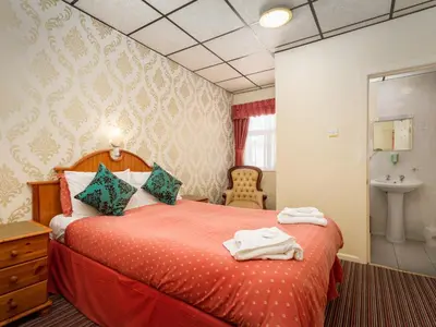 a hotel room with a bed and a sink at Oak Lea Hotel in Blackpool
