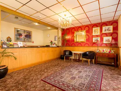 a salon with a table and chairs and a mirror at Oak Lea Hotel in Blackpool