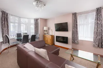 a living room with a couch and a table at Beachcliffe Lodge Apartments in Blackpool