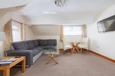 a living room with a couch and a table at Beachcliffe Lodge Apartments in Blackpool
