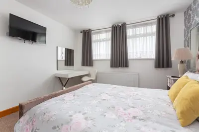 a bedroom with a bed and a desk at Beachcliffe Lodge Apartments in Blackpool