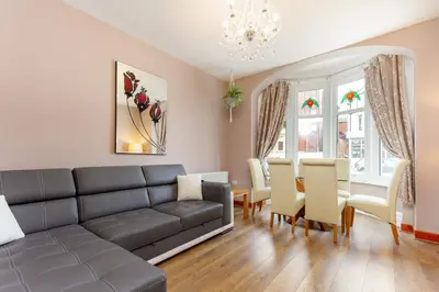 a living room with a couch and a table and chairs at Beachcliffe Lodge Apartments in Blackpool