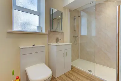 a bathroom with a shower and a toilet and a sink at Beachcliffe Lodge Apartments in Blackpool