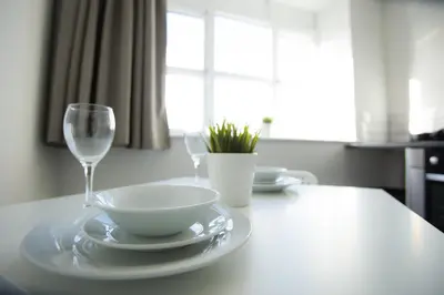 a table with a bowl and a wine glass at Fox Street Apartments in Liverpool