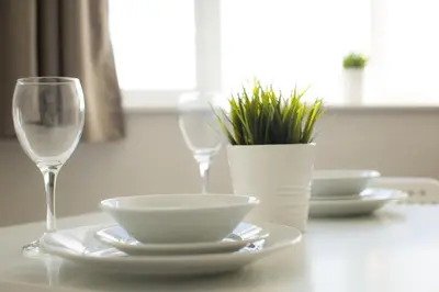 a table with a bowl and a glass of wine at Fox Street Apartments in Liverpool