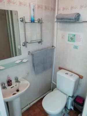 a bathroom with a white toilet and a sink at The Shining Diamond in Blackpool