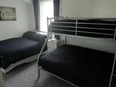 two bunk beds in a room with a window at The Shining Diamond in Blackpool